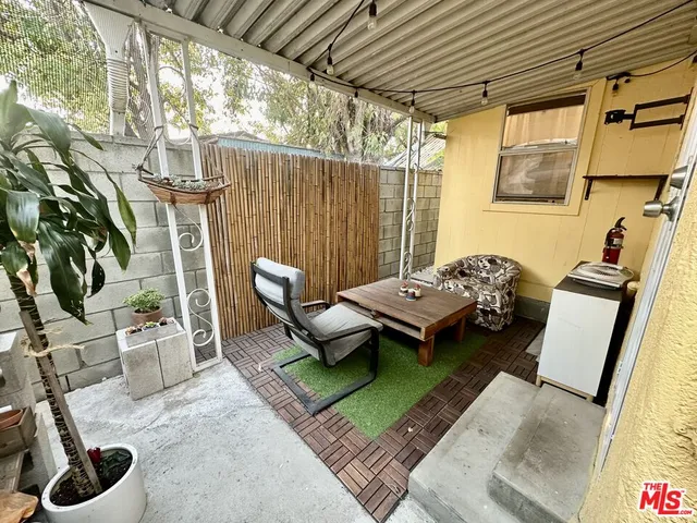 a backyard of a house with outdoor seating