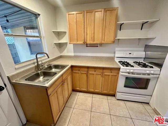 a kitchen with a sink stove and cabinets