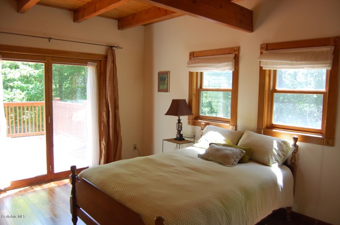 86 Leland Road Becket, MA 01223 - Photo 12 of 37 a bedroom with a bed and a large window