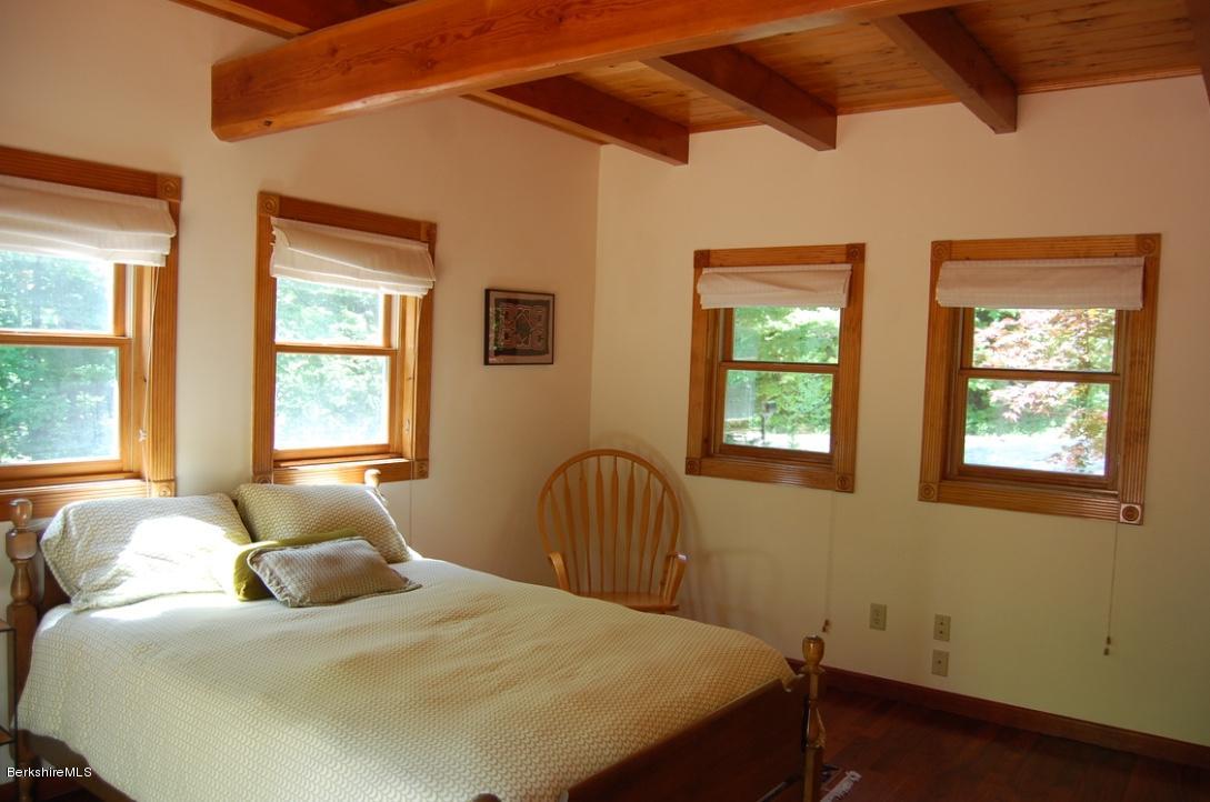 86 Leland Road Becket, MA 01223 - Photo 13 of 37 a bedroom with a bed and wooden floor