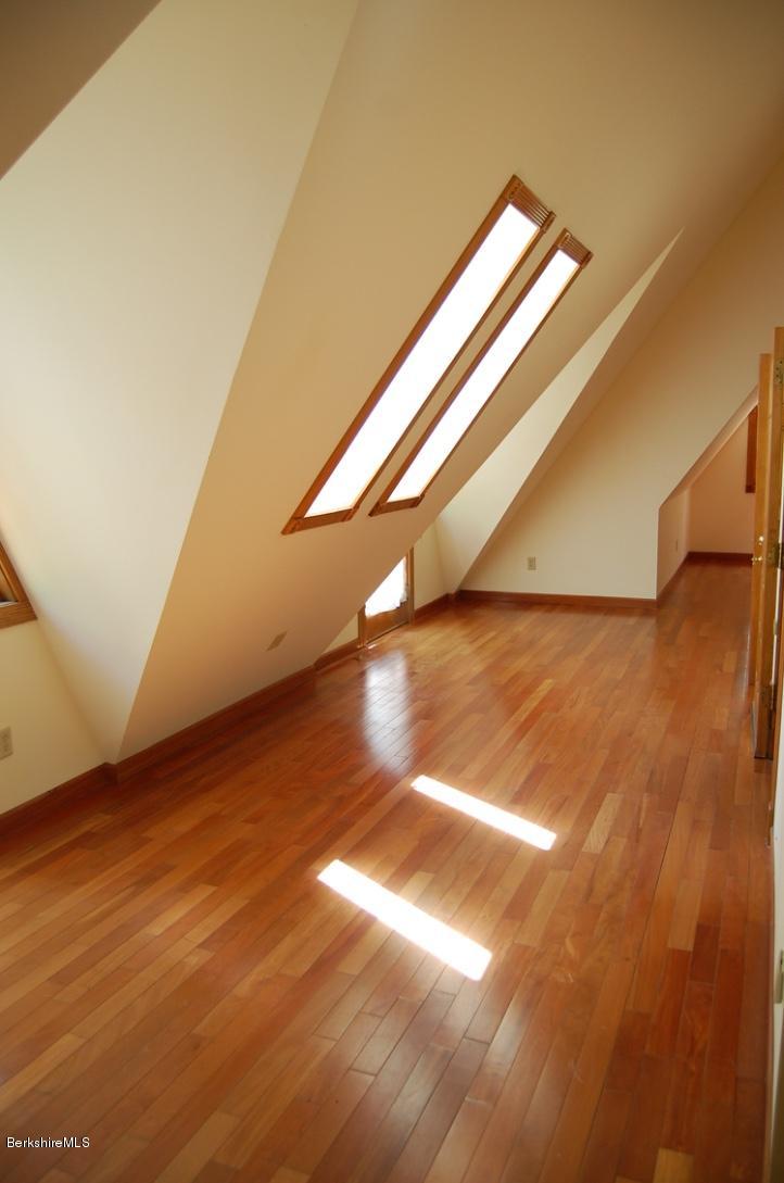 86 Leland Road Becket, MA 01223 - Photo 14 of 37 a view of an empty room with wooden floor