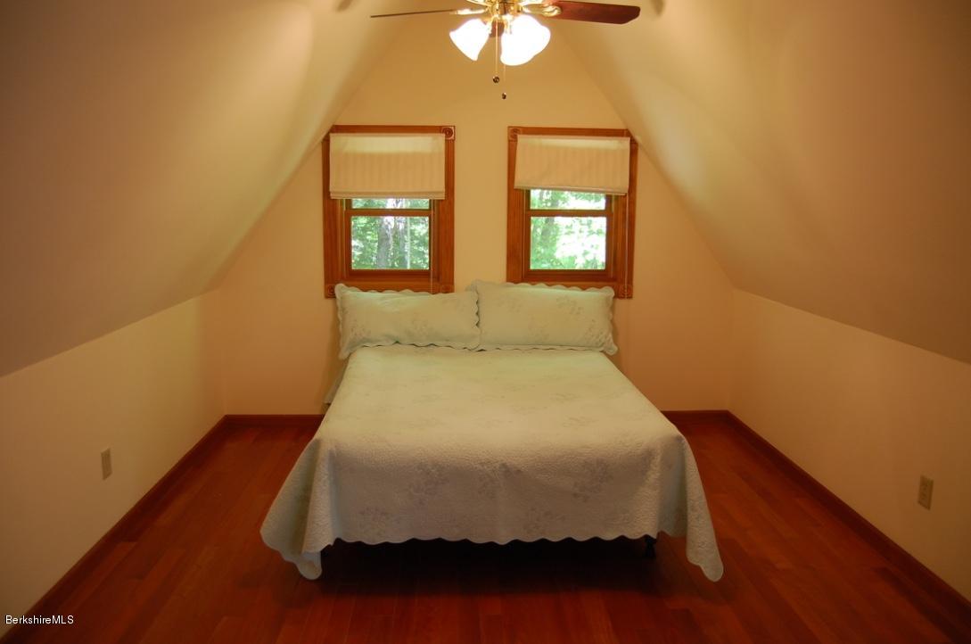86 Leland Road Becket, MA 01223 - Photo 16 of 37 a bed sitting in a bedroom next to a window