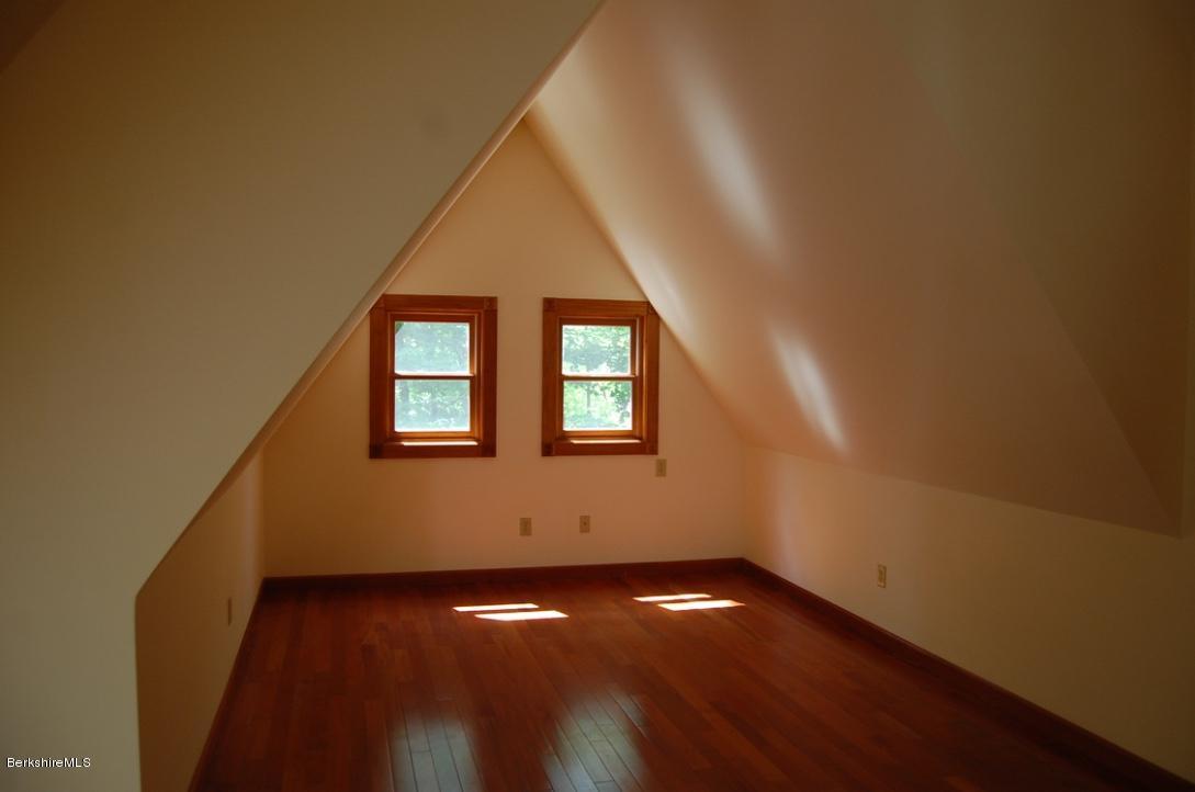 86 Leland Road Becket, MA 01223 - Photo 17 of 37 a view of an empty room with wooden floor and a window