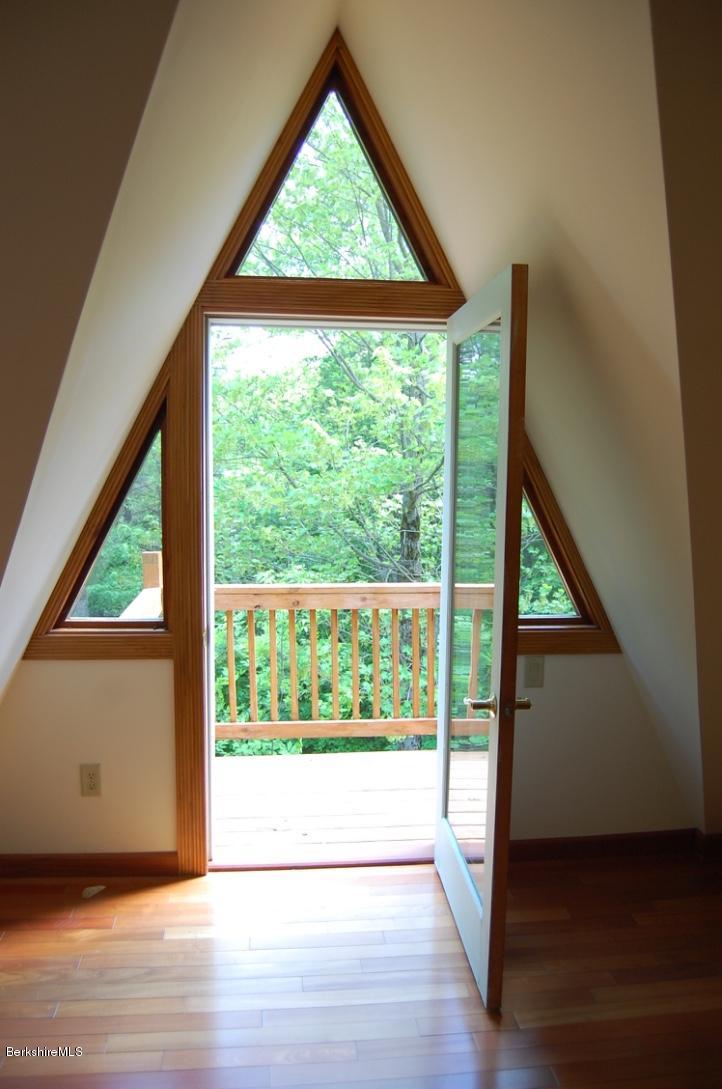 86 Leland Road Becket, MA 01223 - Photo 18 of 37 an empty room with wooden floor and windows