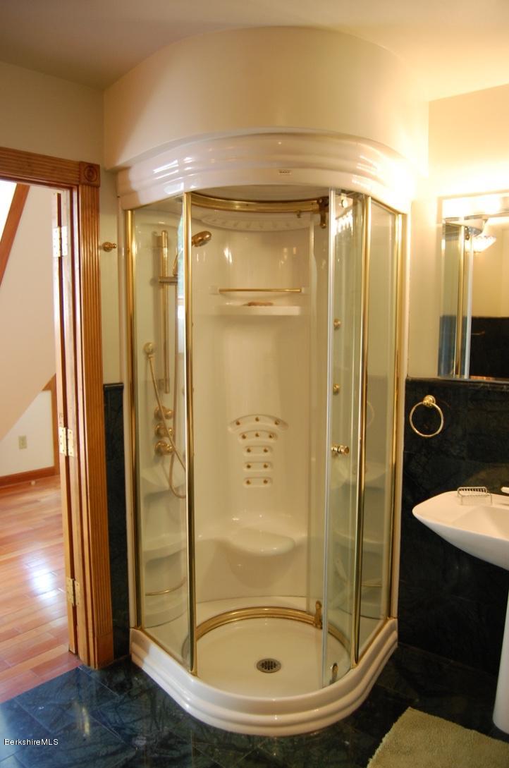 86 Leland Road Becket, MA 01223 - Photo 21 of 37 a bathroom with a glass shower door and a sink