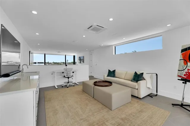 a bedroom with furniture and a flat screen tv
