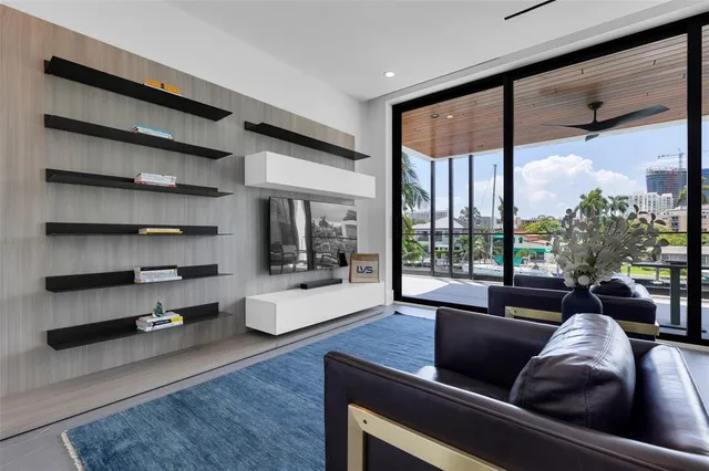 a dining room with furniture and a floor to ceiling window