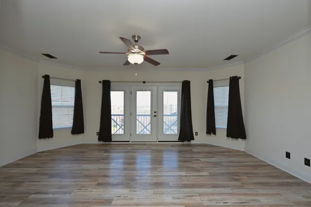 wooden floor in an empty room with a window