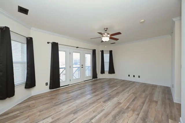 a view of a balcony with chairs and a potted plant