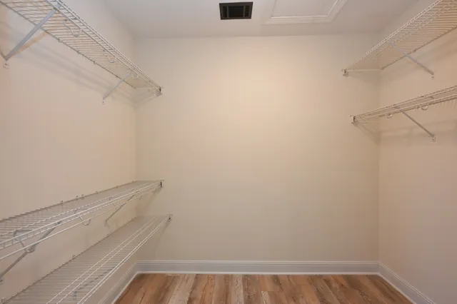 a view of a patio with dining table and chairs with wooden floor