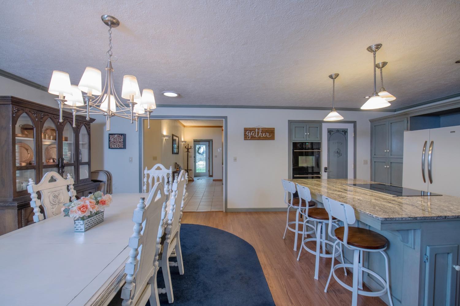 2695 Paso Pass Road Mariposa, CA 95338 - Photo 17 of 56 a view of a dining room and livingroom with furniture wooden floor a chandelier