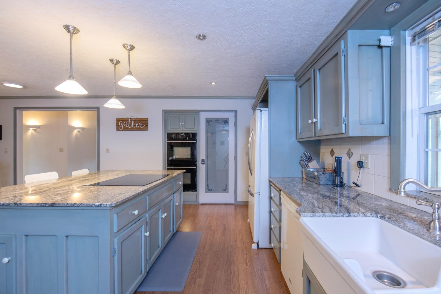 2695 Paso Pass Road Mariposa, CA 95338 - Photo 18 of 56 a kitchen with granite countertop a sink and cabinets