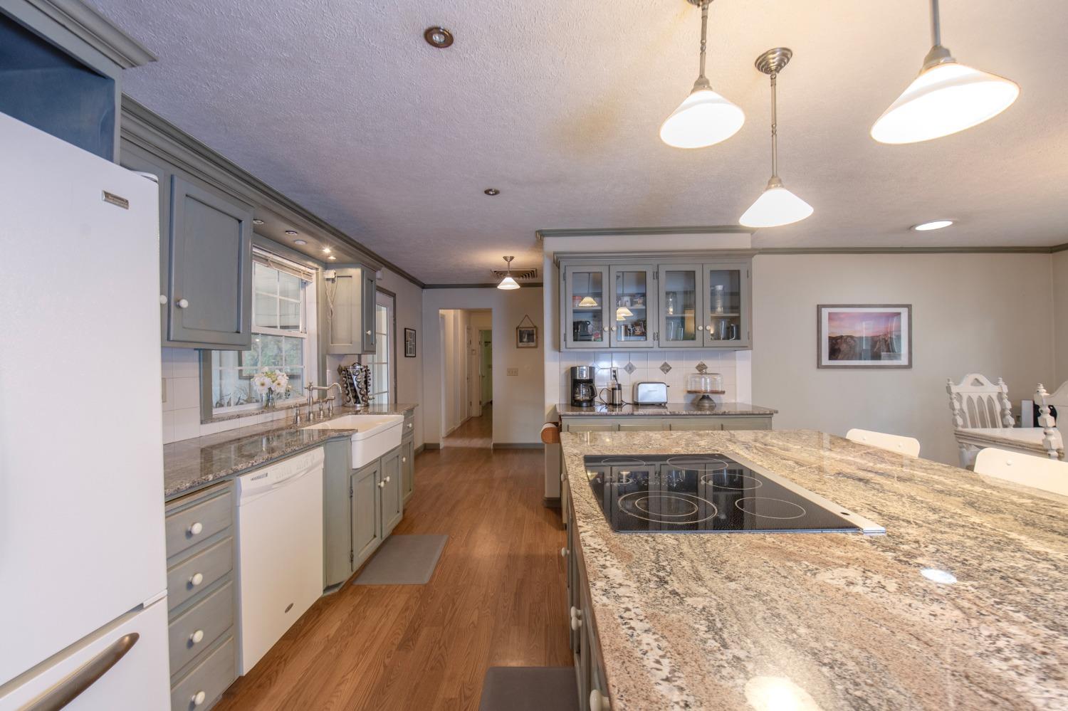 2695 Paso Pass Road Mariposa, CA 95338 - Photo 19 of 56 a large kitchen with kitchen island a sink stainless steel appliances and cabinets