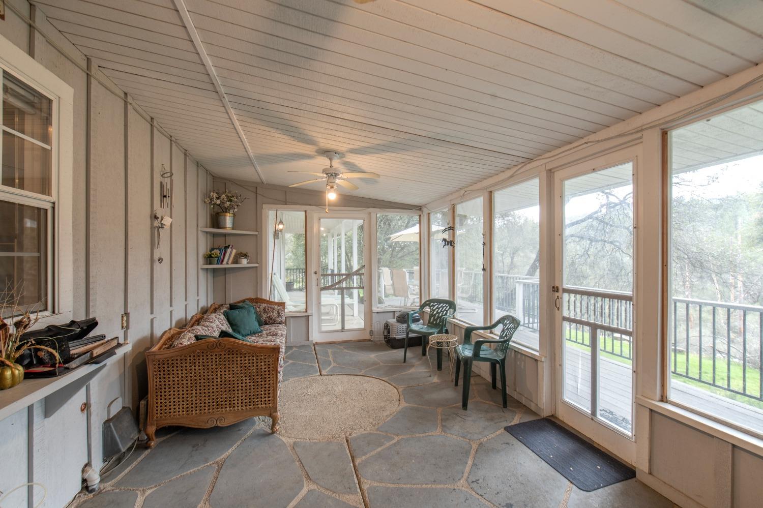 2695 Paso Pass Road Mariposa, CA 95338 - Photo 21 of 56 a living room with furniture and large windows