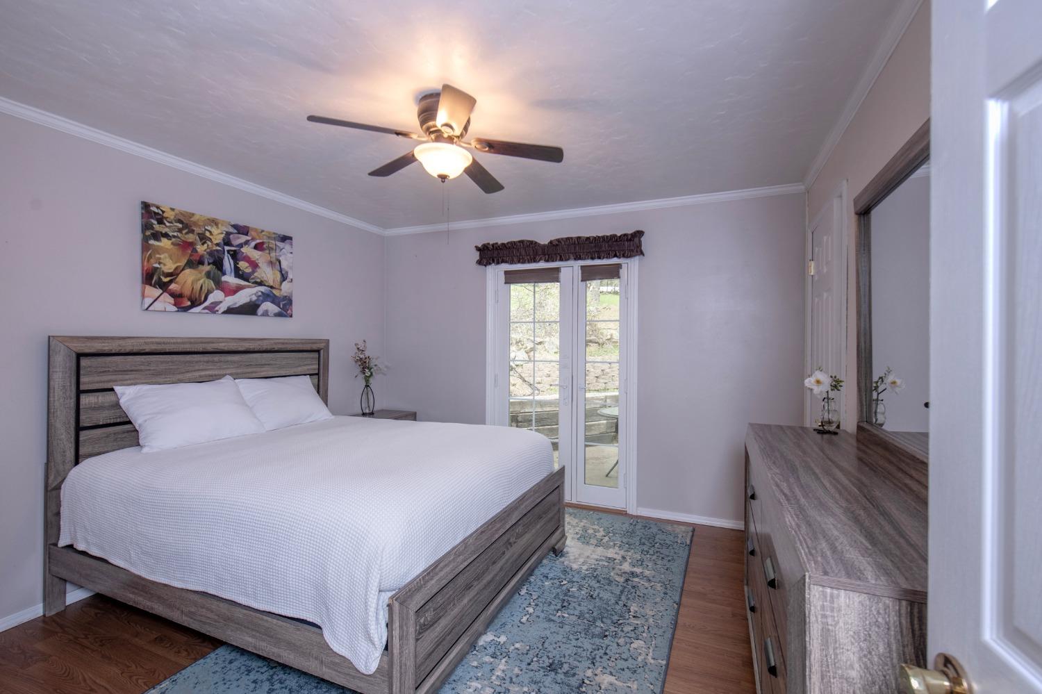 2695 Paso Pass Road Mariposa, CA 95338 - Photo 28 of 56 a bedroom with a bed and a chandelier