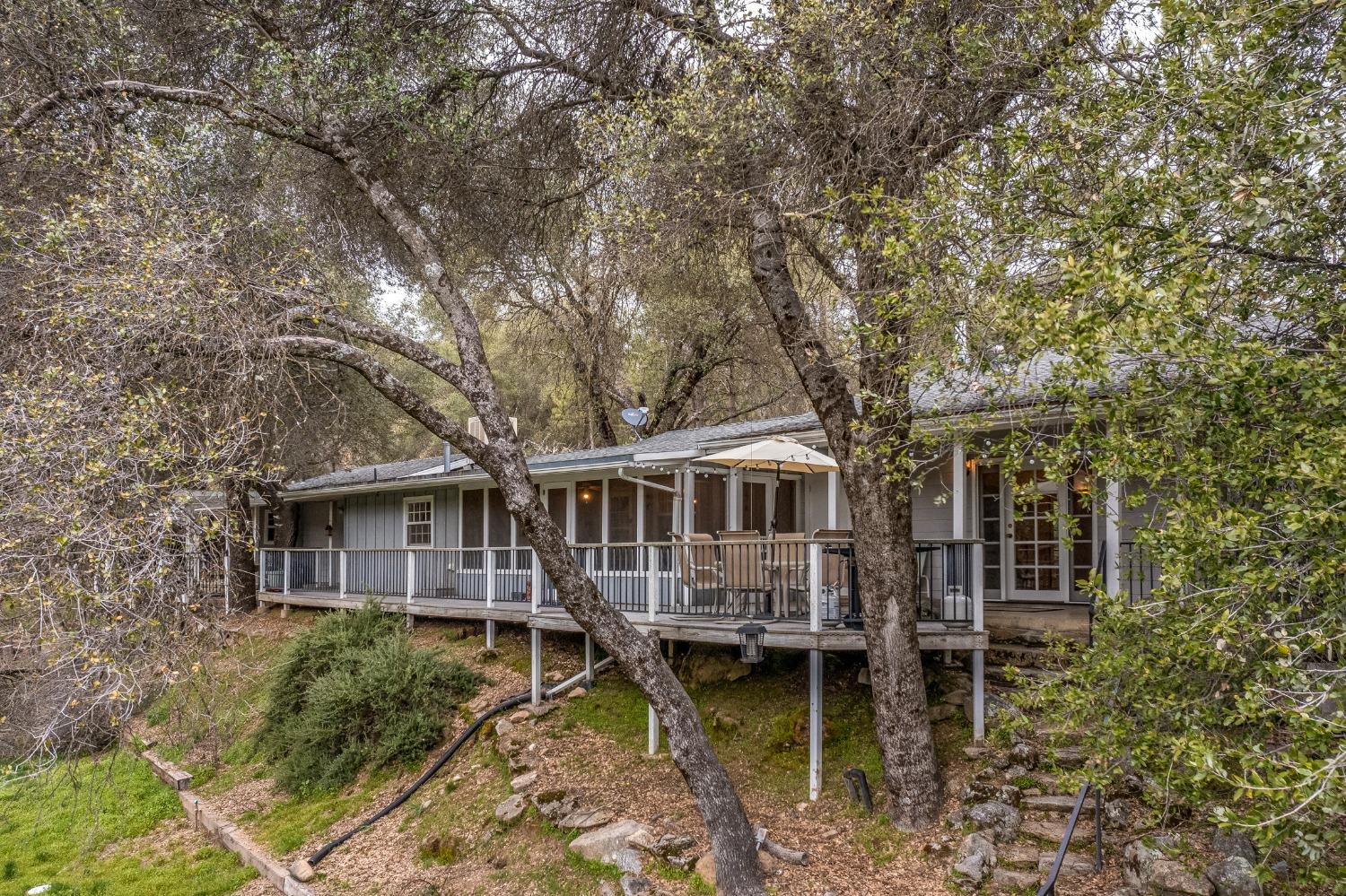 2695 Paso Pass Road Mariposa, CA 95338 - Photo 3 of 56 a aerial view of a house with a small yard and large trees