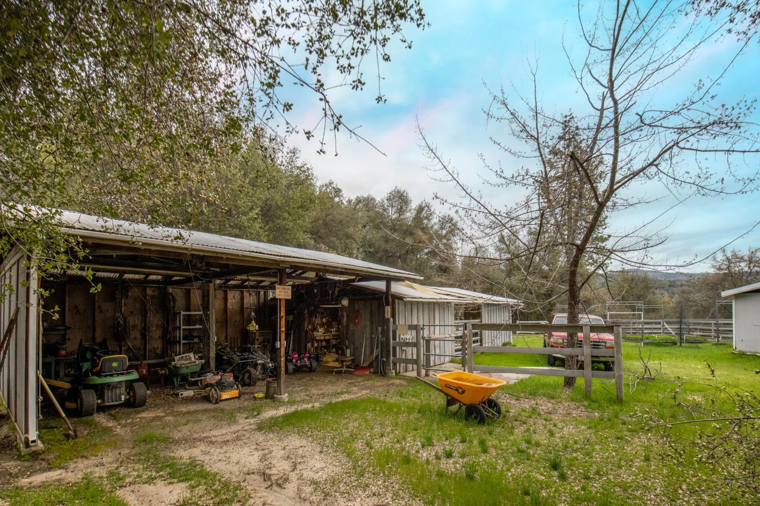 2695 Paso Pass Road Mariposa, CA 95338 - Photo 52 of 56 a view of a chair and tables in the back yard of the house