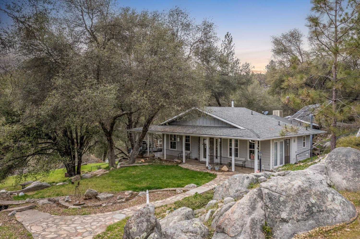 2695 Paso Pass Road Mariposa, CA 95338 - Photo 6 of 56 a front view of a house with a garden