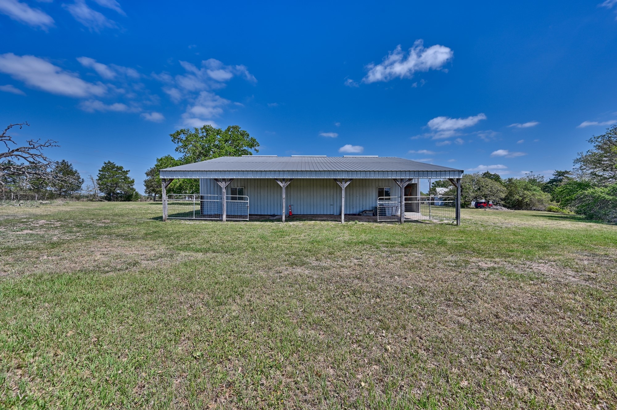 350 Owl Creek Road Giddings, TX 78942 - Photo 15 of 29 Back of house featuring an outbuilding and an exterior structure