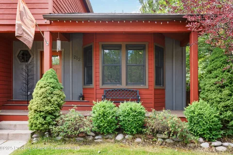 view of front door of house with potted plants