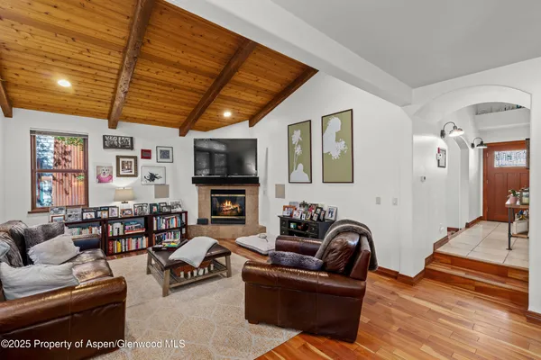 a living room with furniture a couch and a flat screen tv