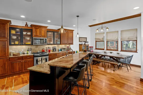 a view of a dining room with furniture and wooden floor