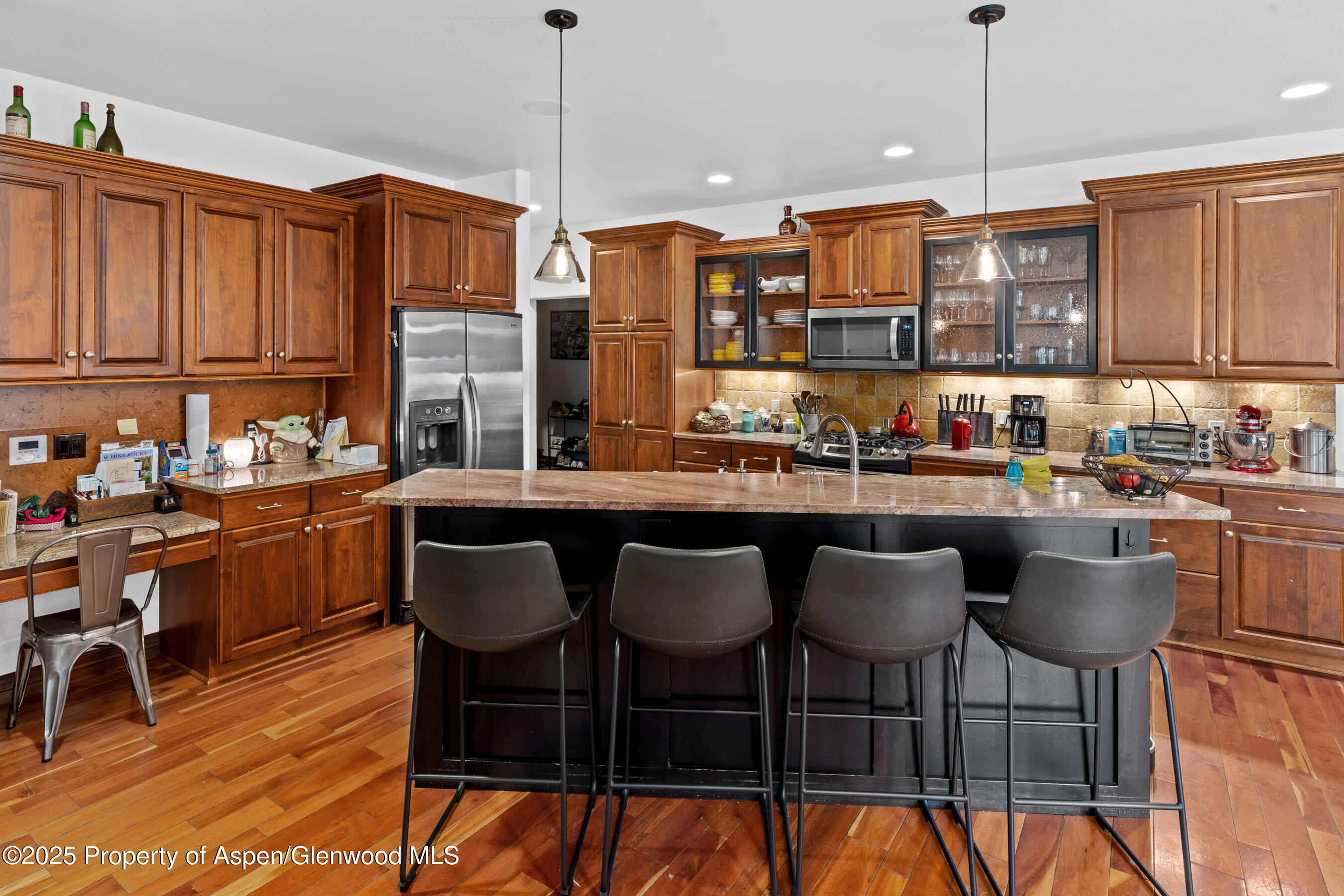 212 Juniper Court Basalt, CO 81621 - Photo 8 of 21 a kitchen with granite countertop a table chairs stove and cabinets