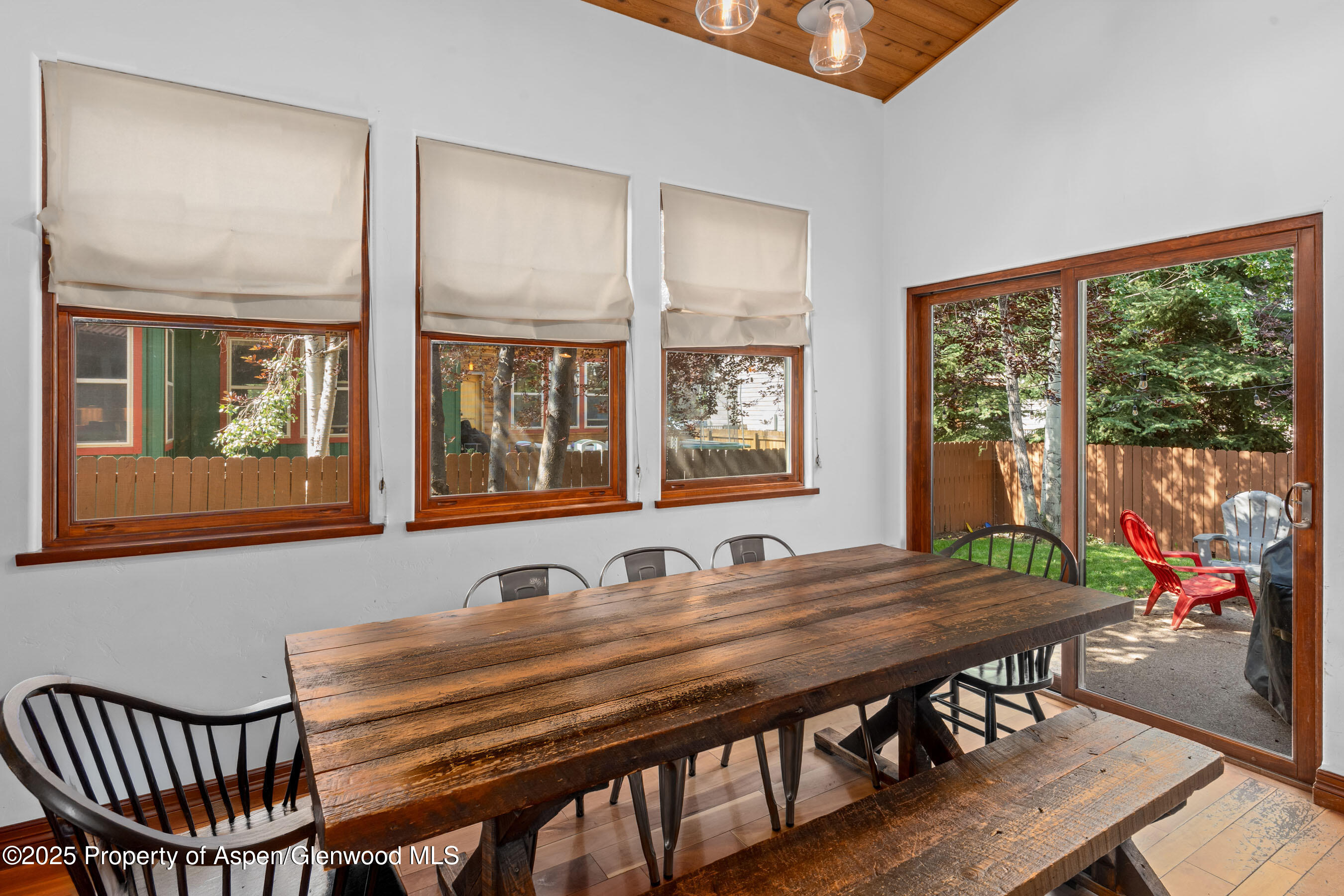 212 Juniper Court Basalt, CO 81621 - Photo 9 of 21 a view of a dining room with furniture large windows and wooden floor