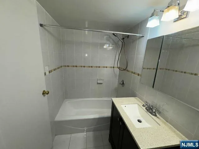 a bathroom with a sink a bath tub and a shower