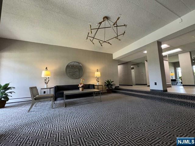 873 Main Street, Unit 3A Hackensack, NJ 07601 - Photo 2 of 15 a living room with furniture a lamp and a chandelier