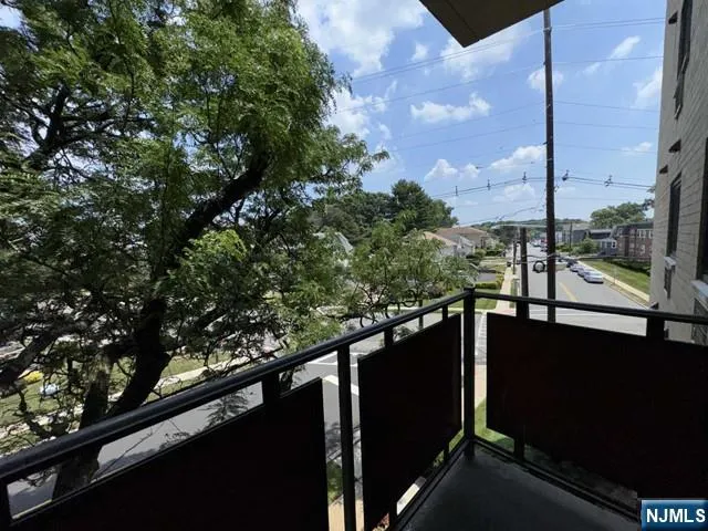 a view of balcony with wooden floor and fence