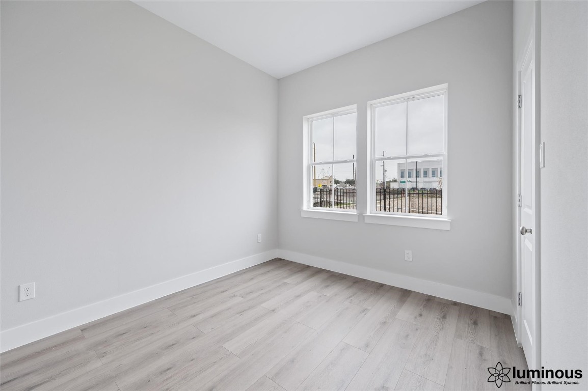 6702 Metro Boulevard, Unit 12 Houston, TX 77083 - Photo 12 of 22 wooden floor in an empty room with a window
