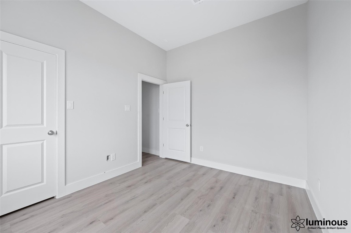 6702 Metro Boulevard, Unit 12 Houston, TX 77083 - Photo 14 of 22 a view of an empty room with wooden floor