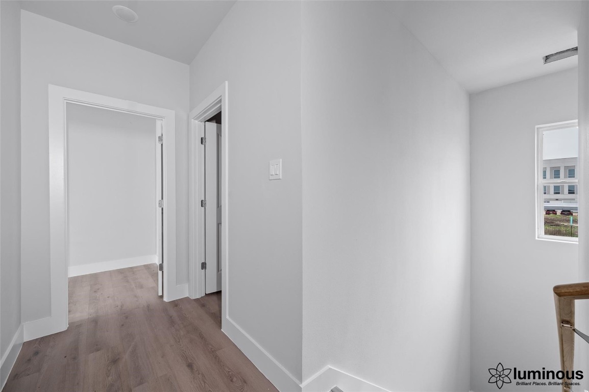 6702 Metro Boulevard, Unit 12 Houston, TX 77083 - Photo 16 of 22 a view of a hallway with wooden floor
