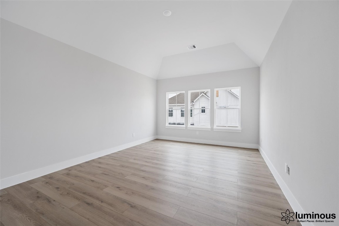 6702 Metro Boulevard, Unit 12 Houston, TX 77083 - Photo 18 of 22 a view of an empty room with wooden floor and a window