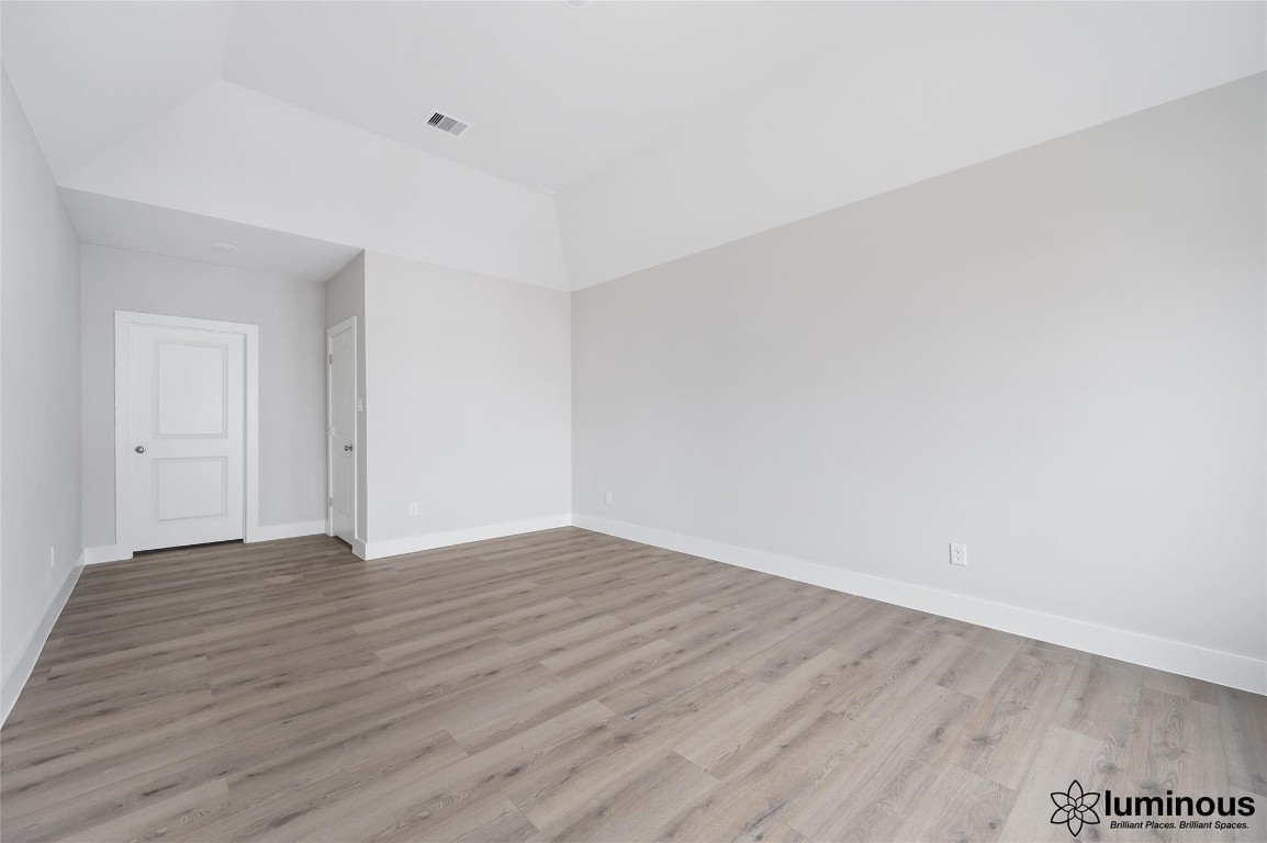 6702 Metro Boulevard, Unit 12 Houston, TX 77083 - Photo 19 of 22 a view of an empty room with wooden floor
