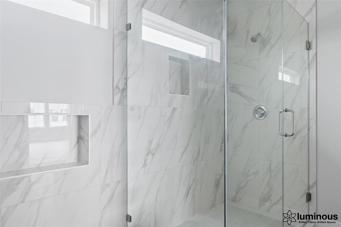6702 Metro Boulevard, Unit 12 Houston, TX 77083 - Photo 21 of 22 a bathroom with a glass shower door