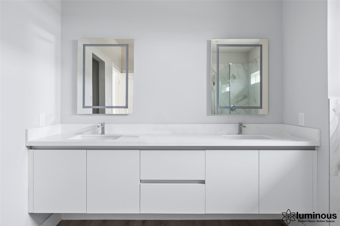 6702 Metro Boulevard, Unit 12 Houston, TX 77083 - Photo 22 of 22 a bathroom with a sink and a mirror