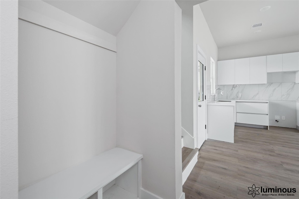 6702 Metro Boulevard, Unit 12 Houston, TX 77083 - Photo 4 of 22 a view of a kitchen with wooden floor