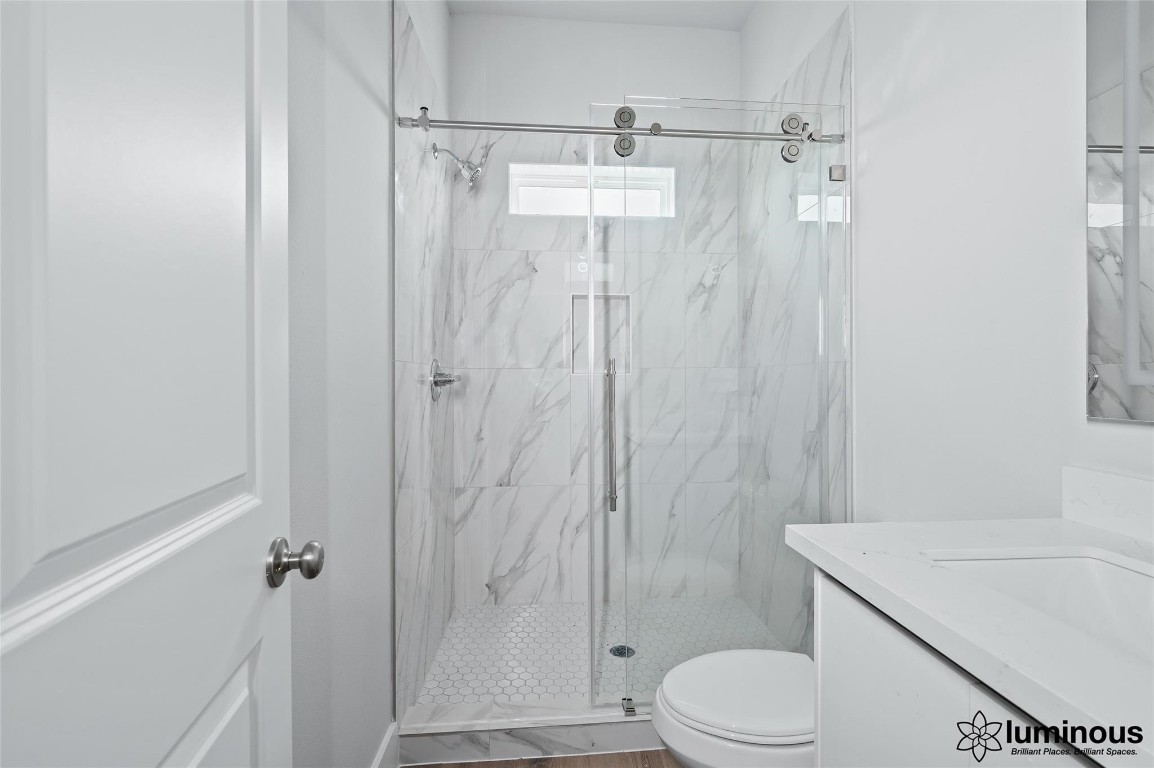 6702 Metro Boulevard, Unit 12 Houston, TX 77083 - Photo 5 of 22 a bathroom with a shower a toilet and a sink