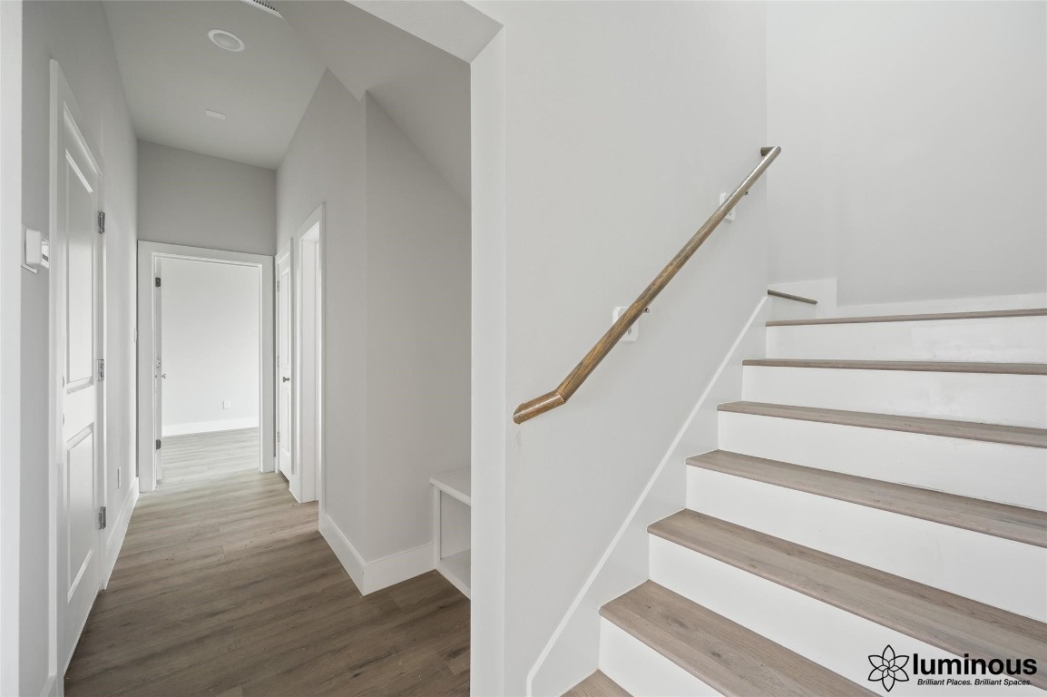 6702 Metro Boulevard, Unit 12 Houston, TX 77083 - Photo 6 of 22 a view of staircase with wooden floor and white walls