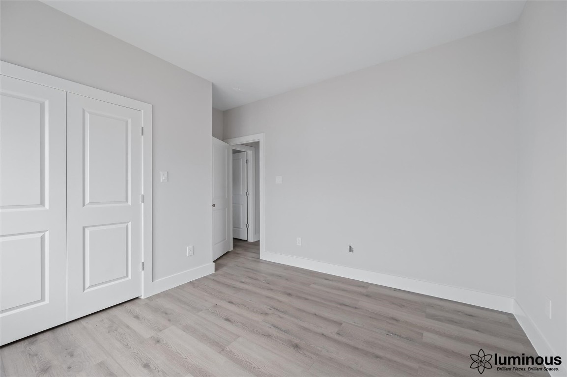 6702 Metro Boulevard, Unit 12 Houston, TX 77083 - Photo 10 of 22 a view of an empty room with wooden floor