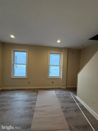a view of room with window and a ceiling fan