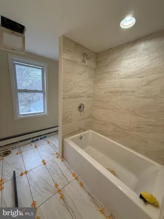 a bathroom with a bathtub and shower