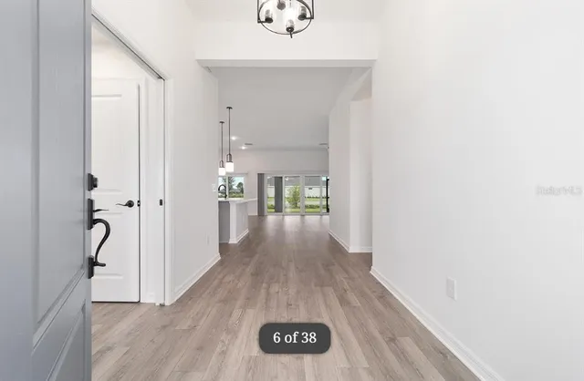 a view of a hallway view with wooden floor and staircase