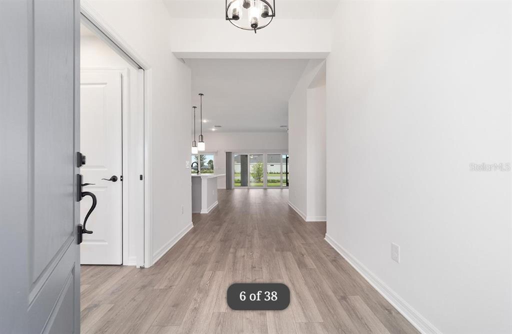 1917 Panlilio Loop The Villages, FL 34762 - Photo 2 of 11 a view of a hallway view with wooden floor and staircase