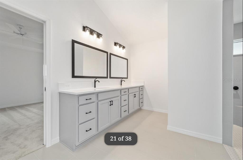 1917 Panlilio Loop The Villages, FL 34762 - Photo 8 of 11 a bathroom with a double vanity sink and a mirror