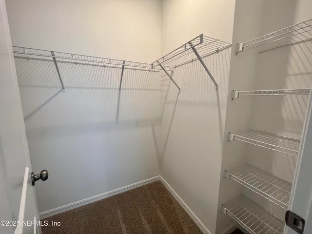 a bathroom with a toilet a sink a mirror and vanity