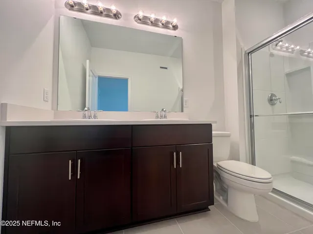 a view of a hallway with wooden shelves