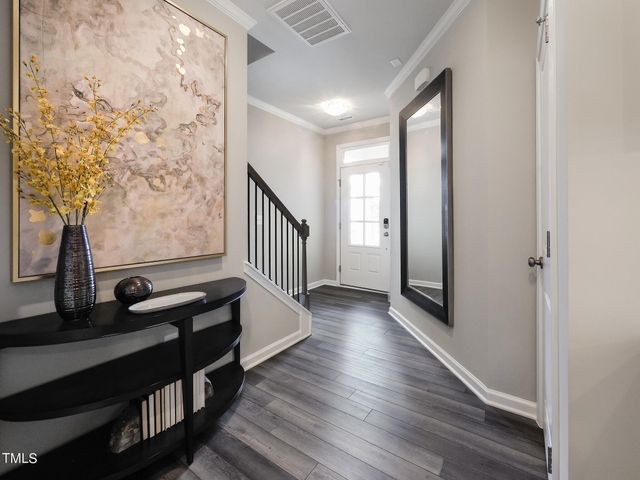 a view of a hallway with wooden floor and stairs